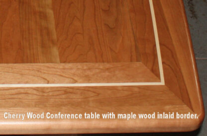 Inlaid Cherry wood conference room table with a maple border inlay. 7-31-23